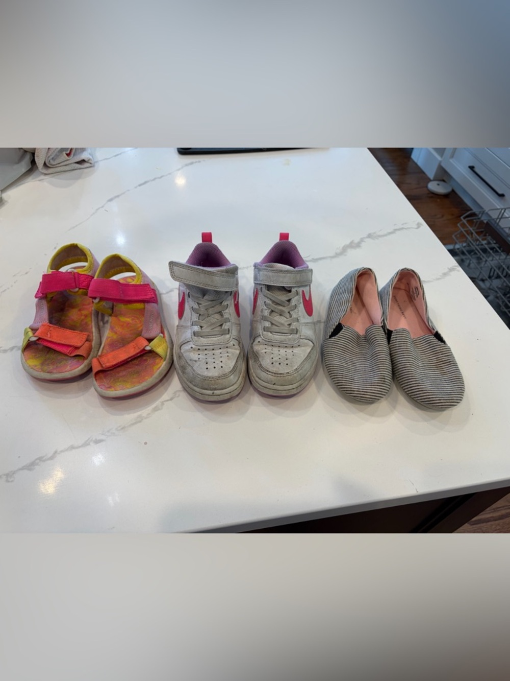 3 pairs of Kids Shoes - Size 11, 12, 12 from our left to right. Merrill, Nike